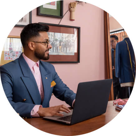 Male wearing a suit on his laptop.